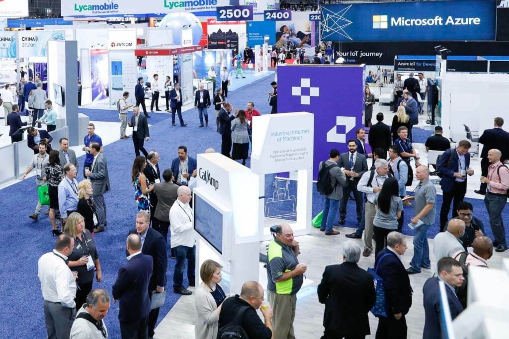 Visitors networking and exploring exhibition stands at MWC Las Vegas.